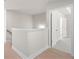 Bright hallway with light hardwood floors, showcasing an open doorway with white trim at 920 Melody Ridge Ln, Buford, GA 30518