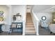 Inviting entryway with staircase, bench seating, and stylish decor for a warm and welcoming ambiance at 166 Aster Avenue, Locust Grove, GA 30248