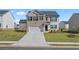 Charming two-story home boasts a brick and siding exterior, complemented by a well-manicured lawn and an attached two-car garage at 166 Aster Avenue, Locust Grove, GA 30248
