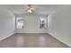 Bright bedroom featuring hardwood flooring, two windows offering natural light, and a ceiling fan at 2500 Waterstone Way, Marietta, GA 30062