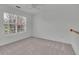 Bright, carpeted bedroom with a large window and neutral walls at 2500 Waterstone Way, Marietta, GA 30062
