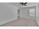 Neutral bedroom offers carpet, white walls, ceiling fan and an archway to another room at 2500 Waterstone Way, Marietta, GA 30062