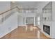 Bright living room boasts a fireplace, tall ceilings, and gleaming hardwood floors at 2500 Waterstone Way, Marietta, GA 30062