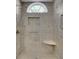 Shower with glass enclosure, tiled walls, and arched window at 2500 Waterstone Way, Marietta, GA 30062