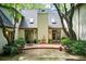 Backyard featuring brick patio, mature trees, and natural light at 305 Heards Ferry Rd, Atlanta, GA 30328