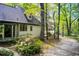 A view of the house with beautiful landscaping and a long driveway surrounded by mature trees at 305 Heards Ferry Rd, Atlanta, GA 30328