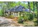 Exterior view of a well-maintained home with mature trees, a manicured lawn, and a mailbox at 305 Heards Ferry Rd, Atlanta, GA 30328