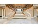Elegant grand staircase featuring wood banisters and marble floors, creating a luxurious and inviting entry at 305 Heards Ferry Rd, Atlanta, GA 30328