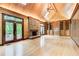 Large living room with a stone fireplace, custom built-ins, and natural light from the french doors at 305 Heards Ferry Rd, Atlanta, GA 30328