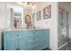 Beautiful double vanity with a granite countertop and teal cabinets next to a glass enclosed shower at 3665 Essex Ave # 28, Atlanta, GA 30339