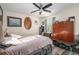 Comfortable bedroom with ceiling fan, wood floors and a collection of decorations and personal items at 3665 Essex Ave # 28, Atlanta, GA 30339