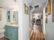 Hallway with hardwood floors and a teal bathroom on the left which leads into an open living space at 3665 Essex Ave # 28, Atlanta, GA 30339