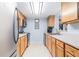 Efficient kitchen with wooden cabinets and stainless-steel appliances is well lit and ready for cooking at 3665 Essex Ave # 28, Atlanta, GA 30339