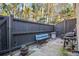 Private patio with dark stained fence, grill, and bench seating - perfect for outdoor relaxation at 3665 Essex Ave # 28, Atlanta, GA 30339