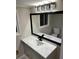 Bathroom featuring a modern vanity with a large mirror and contemporary lighting at 4844 Fairforest Dr, Stone Mountain, GA 30088