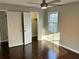 Light-filled bedroom with hardwood floors, ceiling fan, closet, and ample natural light at 4844 Fairforest Dr, Stone Mountain, GA 30088