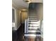 Inviting foyer features hardwood floors, a staircase with white risers, and a modern light fixture at 4844 Fairforest Dr, Stone Mountain, GA 30088