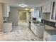 Updated kitchen boasting white cabinets, modern appliances, and marble tile floors at 4844 Fairforest Dr, Stone Mountain, GA 30088
