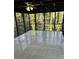 Relaxing screened patio with tile flooring and wooded views for enjoying the outdoors at 4844 Fairforest Dr, Stone Mountain, GA 30088