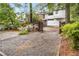 Gravel parking area in backyard surrounded by wooden fence and lush trees at 758 Argonne Ne Ave, Atlanta, GA 30308