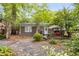 Backyard with a wooden patio, and a gravel parking area surrounded by lush trees at 758 Argonne Ne Ave, Atlanta, GA 30308