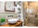 Bathroom featuring a walk-in shower, stone walls, a stone floor, and a stylish sink at 758 Argonne Ne Ave, Atlanta, GA 30308