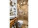 This bathroom has a walk-in shower, stone walls, a stone floor, and a stylish sink at 758 Argonne Ne Ave, Atlanta, GA 30308