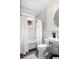 A well-lit bathroom with white subway tile, classic fixtures, and patterned tile flooring at 758 Argonne Ne Ave, Atlanta, GA 30308