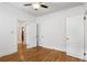 A spacious bedroom featuring hardwood floors, ceiling fan, and multiple doors at 758 Argonne Ne Ave, Atlanta, GA 30308