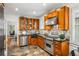 A view of the kitchen showcasing stainless steel appliances, tile floors, and custom cabinetry at 758 Argonne Ne Ave, Atlanta, GA 30308