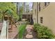 Landscaped backyard with lush greenery, a stone pathway, and a play area with slide and swingset at 4431 Skyland Ne Dr, Atlanta, GA 30342