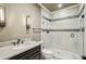 Modern bathroom featuring a glass enclosed shower with gray accents, marble countertop, and decorative sconces at 4431 Skyland Ne Dr, Atlanta, GA 30342