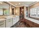 Elegant bathroom featuring dual sinks, marble countertops, walk-in shower and soaking tub under a window at 4431 Skyland Ne Dr, Atlanta, GA 30342