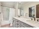 Bright bathroom featuring double sinks, white subway tile, and a shower/tub combination at 4431 Skyland Ne Dr, Atlanta, GA 30342