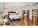 Bedroom showcasing hardwood floors, an accent wall, and custom closet with sliding doors at 4431 Skyland Ne Dr, Atlanta, GA 30342
