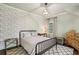 Charming bedroom with distinctive wallpaper, a decorative light fixture, and a neutral-toned geometric patterned rug at 4431 Skyland Ne Dr, Atlanta, GA 30342