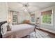 Well-lit bedroom featuring an interesting geometric patterned rug, stylish light fixture, and two large windows at 4431 Skyland Ne Dr, Atlanta, GA 30342