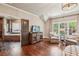 Bright room adjacent to a bath featuring hardwood floors, a TV on credenza, and comfortable seating near large windows at 4431 Skyland Ne Dr, Atlanta, GA 30342
