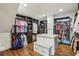 Large walk-in closet with custom shelving, ample hanging space, and a marble-topped island at 4431 Skyland Ne Dr, Atlanta, GA 30342