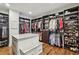 Organized walk-in closet offering plentiful shelving, hanging space, and a center island for storage at 4431 Skyland Ne Dr, Atlanta, GA 30342