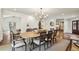 Elegant dining room with a large wood table, seating for eight, and stylish chandelier lighting fixture at 4431 Skyland Ne Dr, Atlanta, GA 30342