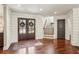 Warm and inviting entryway featuring a wood door with glass, shiplap walls, and hardwood flooring at 4431 Skyland Ne Dr, Atlanta, GA 30342