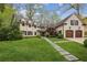 Charming white brick home with lush front lawn, walkway, and an attached two-car garage at 4431 Skyland Ne Dr, Atlanta, GA 30342