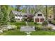 Stately painted brick home with dormer windows, black shutters, and beautiful landscaping at 4431 Skyland Ne Dr, Atlanta, GA 30342