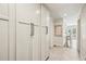 Hallway with herringbone wood floors, large cabinets, and views into the dining room at 4431 Skyland Ne Dr, Atlanta, GA 30342