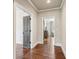 Bright hallway featuring hardwood floors, neutral paint, and open doorway leading to additional rooms at 4431 Skyland Ne Dr, Atlanta, GA 30342
