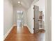 Hallway view showcasing hardwood floors, open doorway, and neutral wall paint at 4431 Skyland Ne Dr, Atlanta, GA 30342