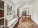 Hallway area featuring built-in bookshelves with seats, a window, and hardwood floors at 4431 Skyland Ne Dr, Atlanta, GA 30342