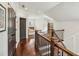Hallway boasts hardwood floors, dark wood railings, and neutral paint that connects different areas at 4431 Skyland Ne Dr, Atlanta, GA 30342