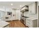 Well-equipped kitchen with stainless steel range, custom cabinets, and marble countertops; open layout at 4431 Skyland Ne Dr, Atlanta, GA 30342